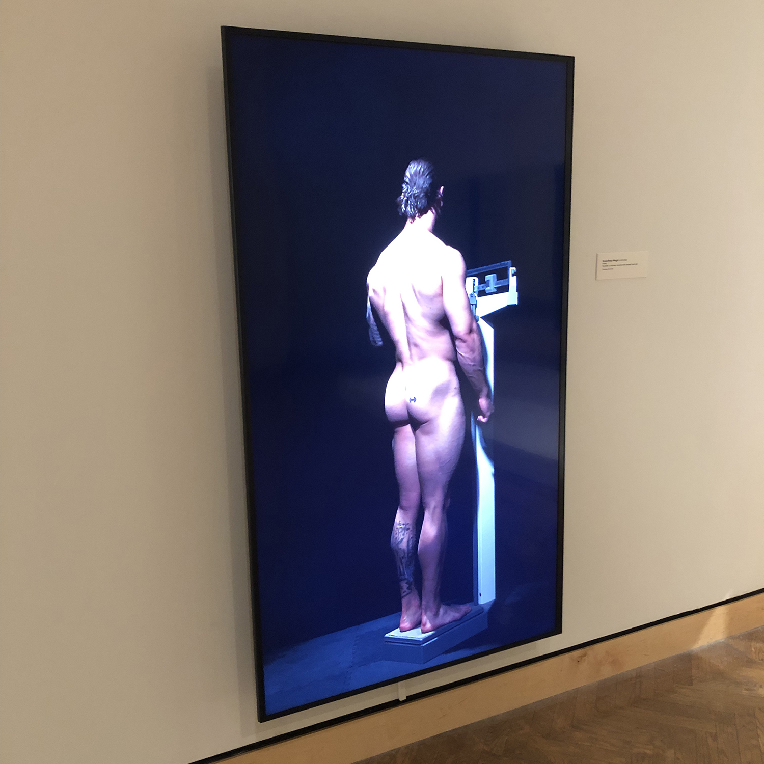 a nude man on a scale on a vertical video screen