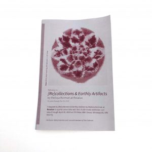 a zine printed in maroon on gray paper