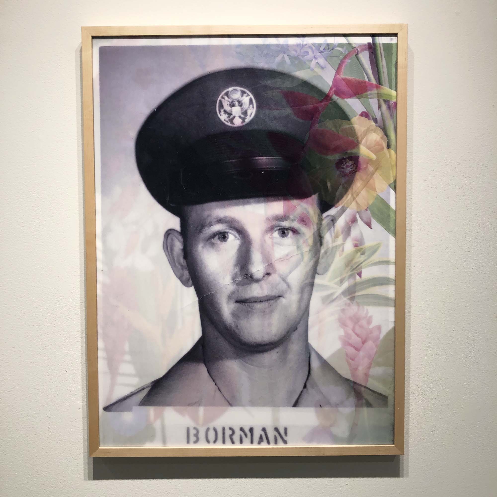 a military portrait of a man with the name Borman and some flowers on the right